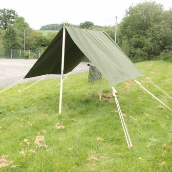 WW2-style Jeep Tent Flysheet Green with wooden poles and ropes set up in grassy field