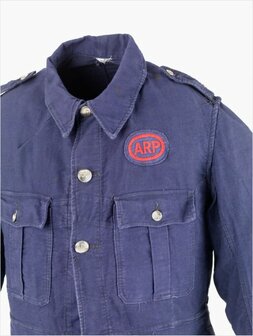 ARP chest pocket badge with red embroidered letters on a dark blue oval backing.
