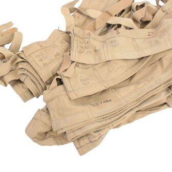 Stack of original British Army tan cotton bandoliers with date stamps and ammunition