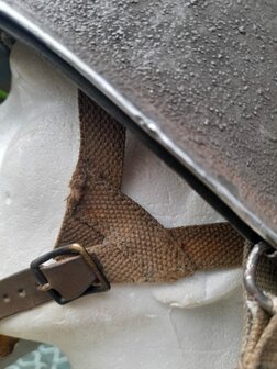Detail of leather A-yoke, buckle and swivel bail fitting on the WWII M1 Airborne helmet