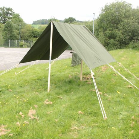 WW2-style Jeep Tent Flysheet Green with wooden poles and ropes set up in grassy field