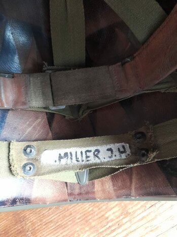 Close-up of the &ldquo;Miller J.H.&rdquo; handwritten name inside the liner webbing
