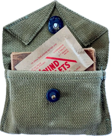 WW2 US Wound Tablets reproduction placed inside a green first aid pouch